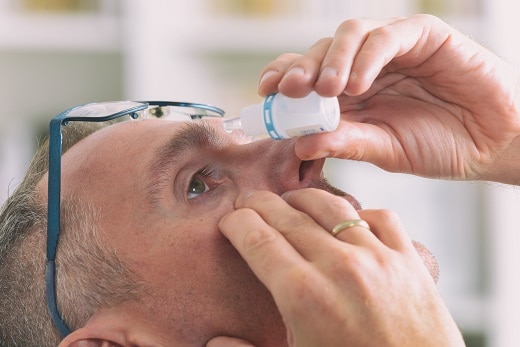 Man applying eye drops