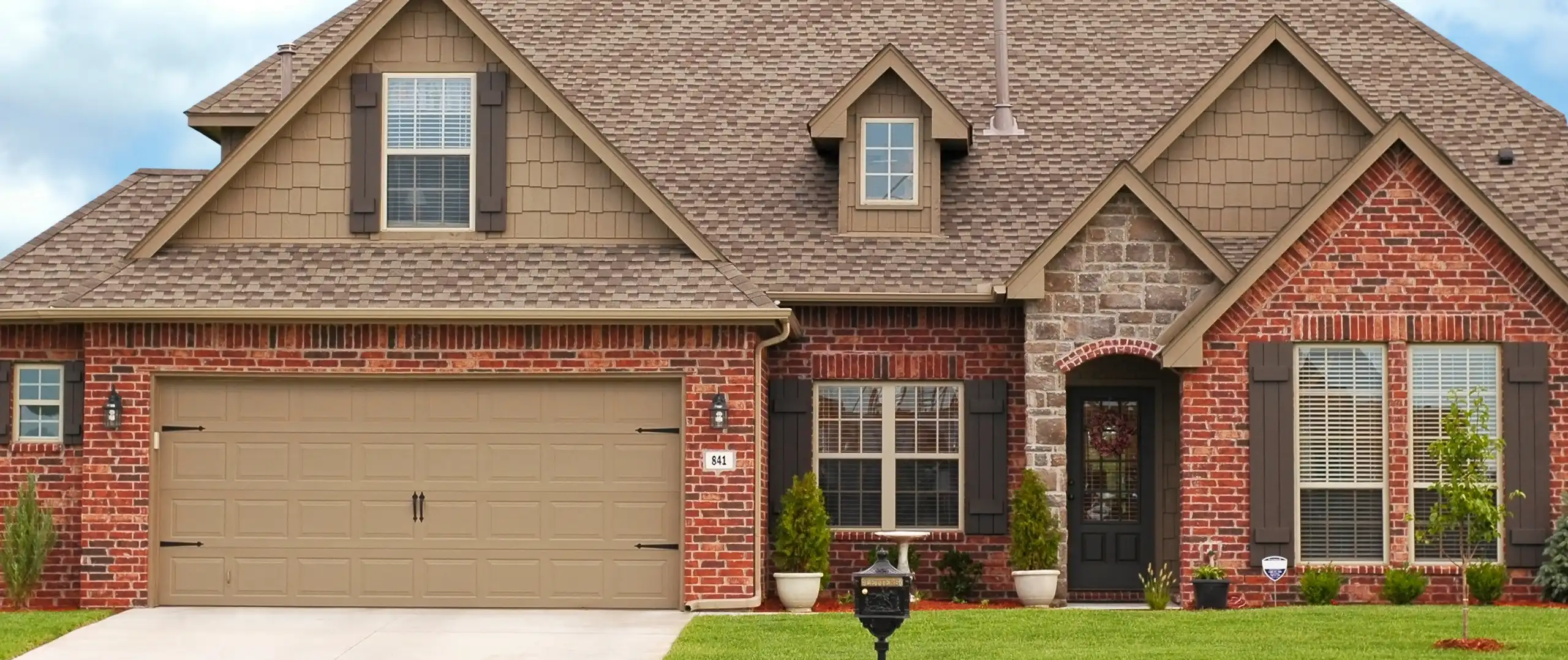 Brick home in a suburban neighborhood - Keep pests away from your home with Arrow Exterminators, Inc. in OK